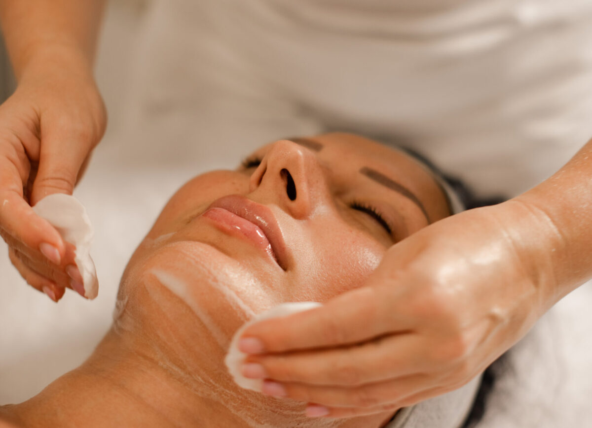Beauty Specialist Preparing Client Skin for Facial Massage